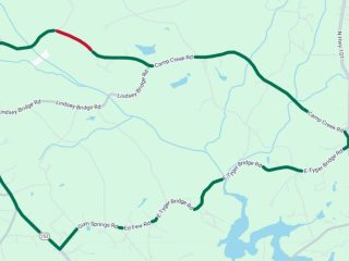 GVL A map showing a winding green road in Greenville County with a short red segment near the top left on Camp Creek Road, indicating traffic congestion or closure due to culvert work among otherwise clear roads.