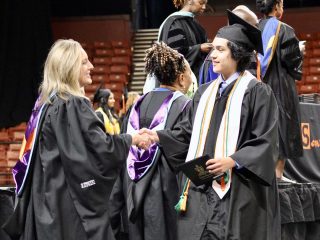 GVL A graduate from the Southside Class of 2025 in a cap and gown shakes hands with a faculty member on stage during graduation, holding a diploma, as other graduates and staff appear in the background of the photos.
