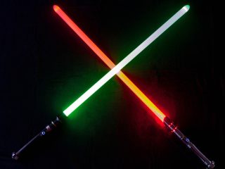 GVL Two lightsabers, one glowing red and the other green, are crossed against a black background, showcasing a dramatic clash of unconventional weaponry.